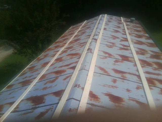 Rusted metal roof panels with new wood purlins before replacement — Storm Damage Roof Repair in Spartansburg by Roofing Brothers
